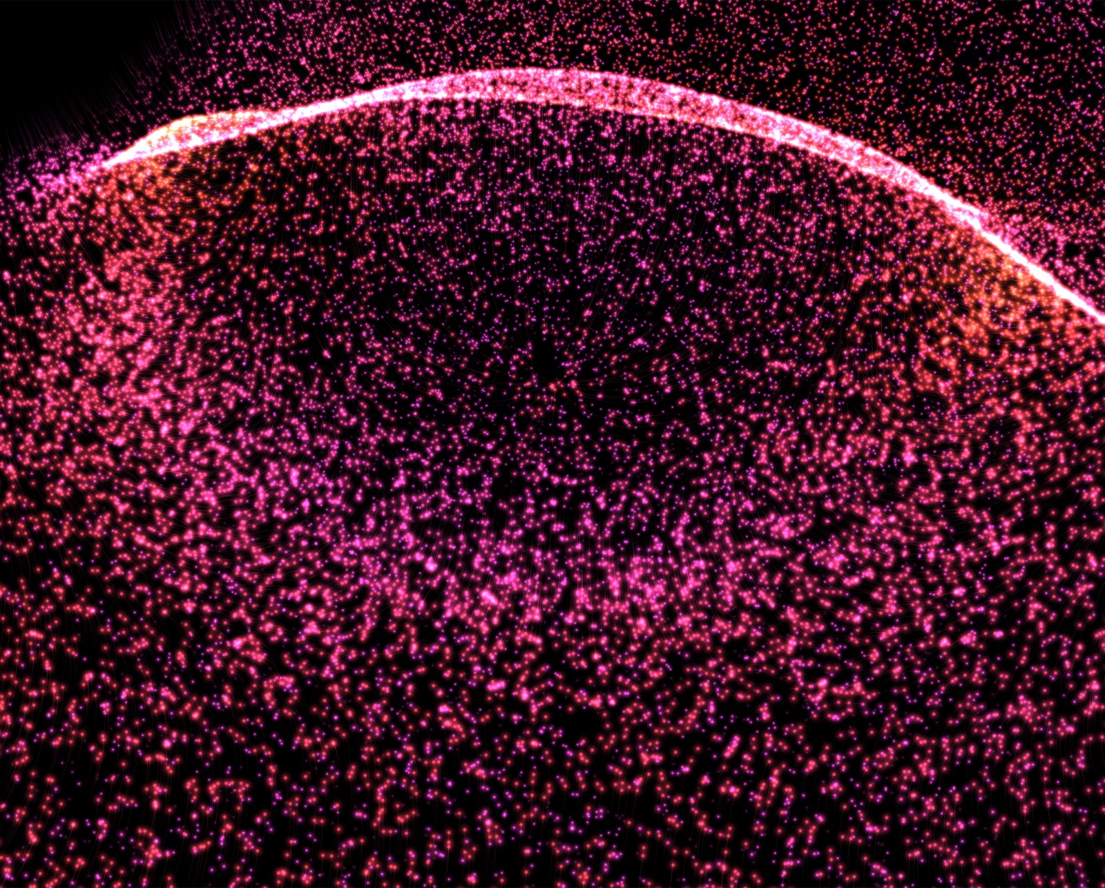 A close, steep view of the ocean wave: a bright pink crest arcing across a frame filled edge to edge with glowing drops.